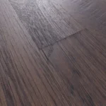 Angled view of textured dark oak flooring planks