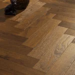 Close-up of oak herringbone parquet floor planks.