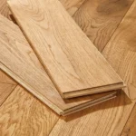Close-up of two oak floor planks on wood flooring.