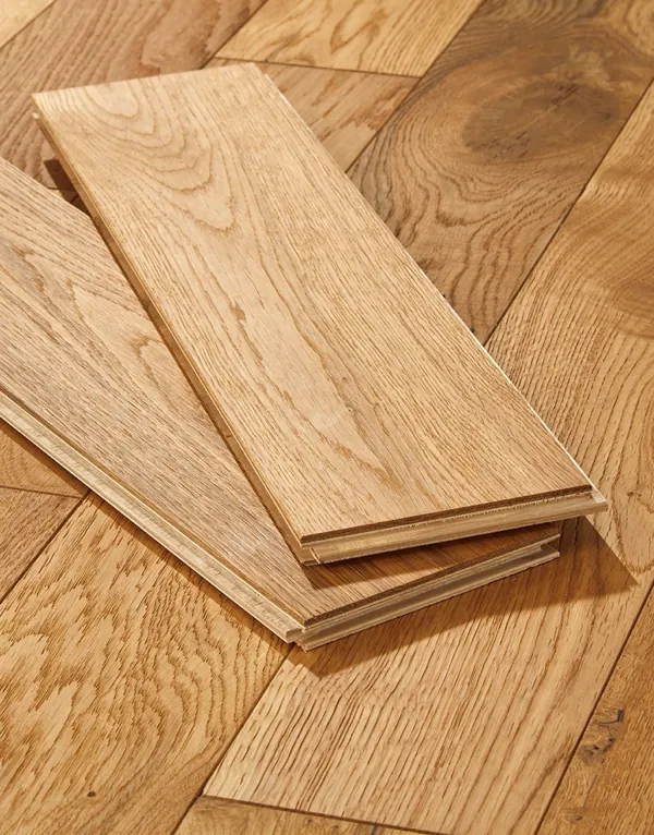 Close-up of two oak floor planks on wood flooring.