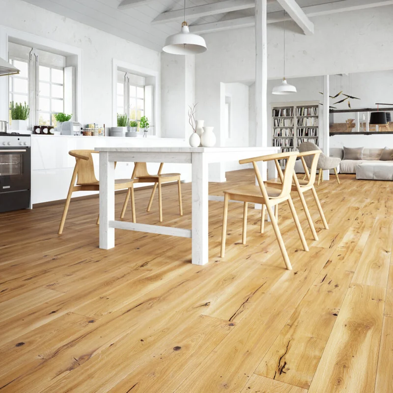 Light oak wood flooring in a bright, white Scandinavian-style dining room.