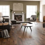 Modern living room with brown wood floors and sage walls