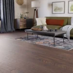 Modern living room with dark wood floors and green sofa