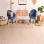 Modern room with blue chairs and light wood flooring