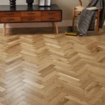 Oak herringbone parquet floor in a furnished room