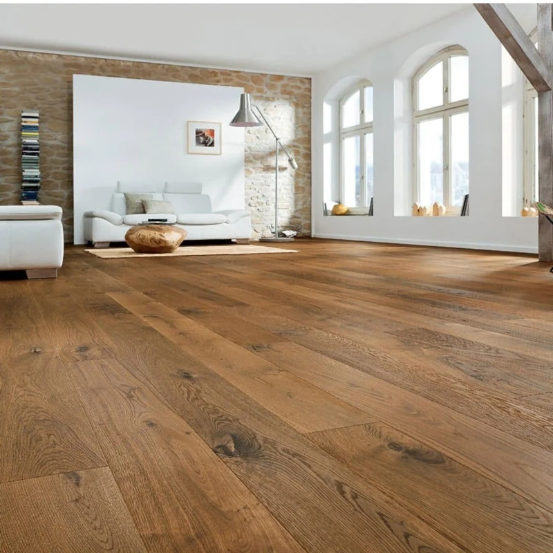 Rustic oak wide-plank flooring in a bright, modern living room with stone walls.