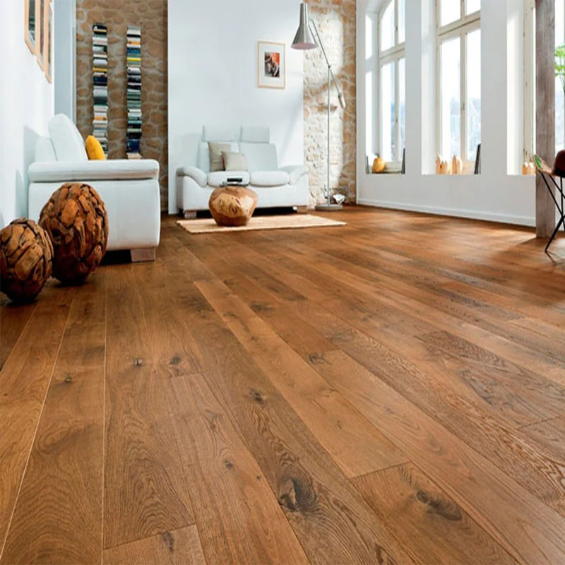 Rustic wide-plank oak flooring in a bright living room with a stone wall.
