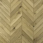 Top-down view of light oak chevron parquet flooring