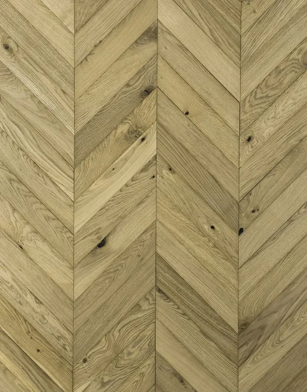 Top-down view of light oak chevron parquet flooring