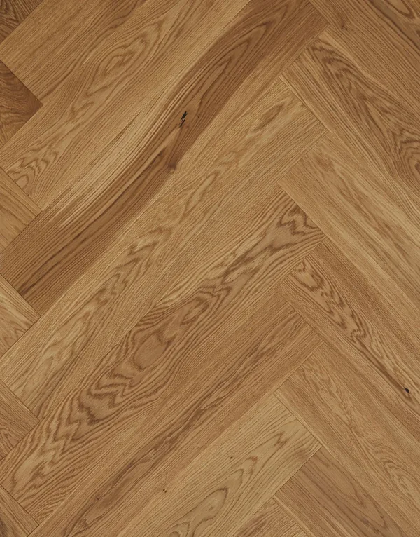 Top-down view of light oak herringbone wood planks