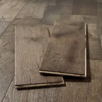 Two dark wood floor planks showing tongue and groove.