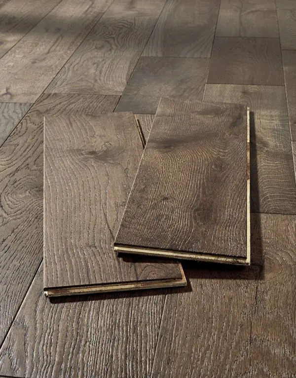 Two dark wood floor planks showing tongue and groove.